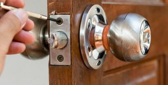 closeup of locksmith on old wood door , repair